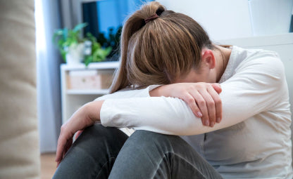 An upset woman sitting with her head down