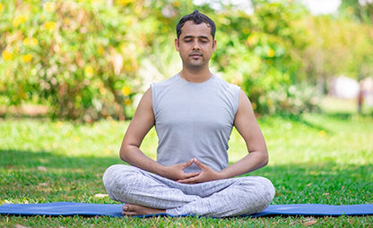 A person doing a yoga pose in the park

