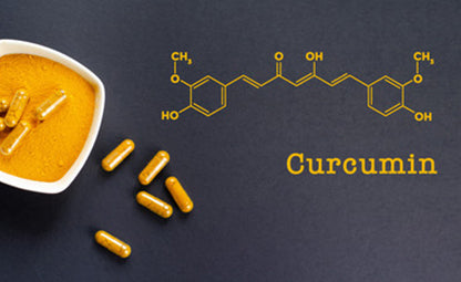 Curcumin powder and capsules on a black background