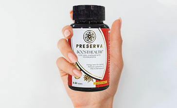 A hand holding Preserva Wellness Boosthealth Tablets