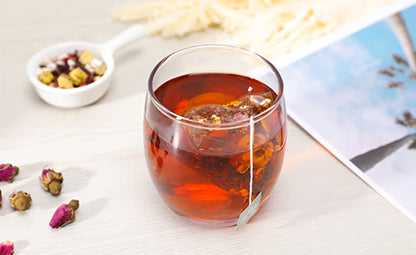 Floral Tea steeping in a glass cup with raw floral leaves