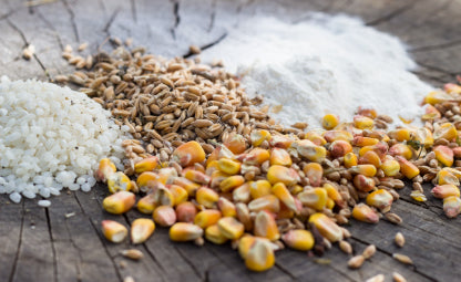 Different types of whole grains on a wooden table