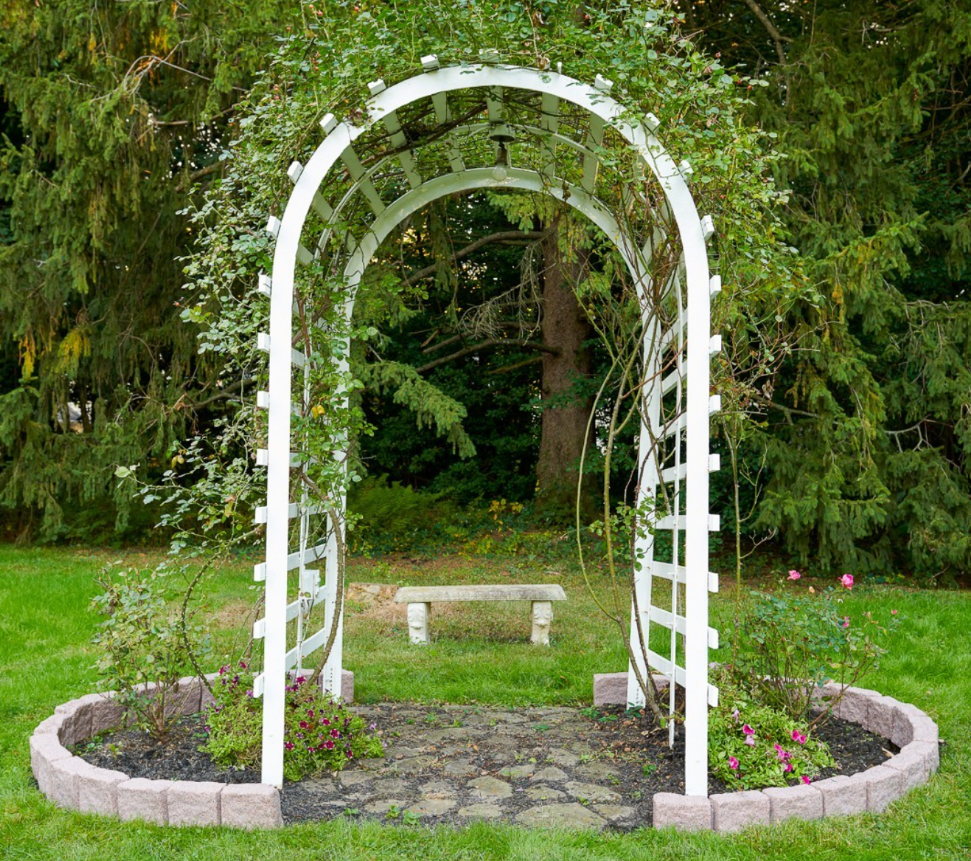 Trellis surrounded by faux stone landscape edging