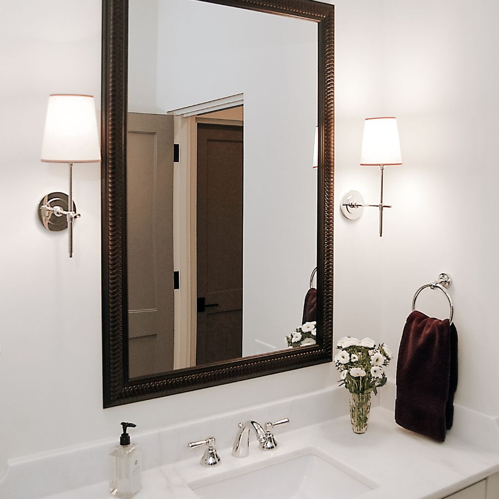 vanity area with sconce lighting