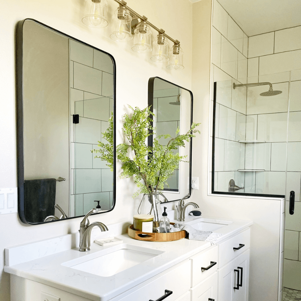 two decorative mirrors over double sink 