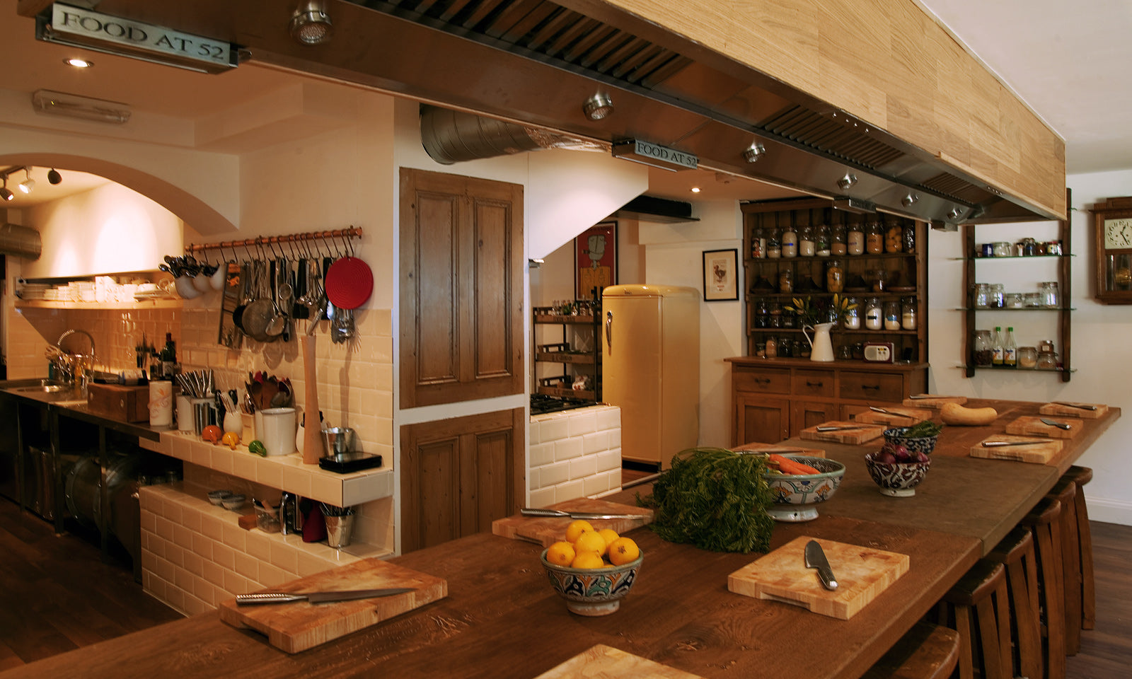 The rustic oak banquet table in our kitchen with a view of the pantry and scullery.