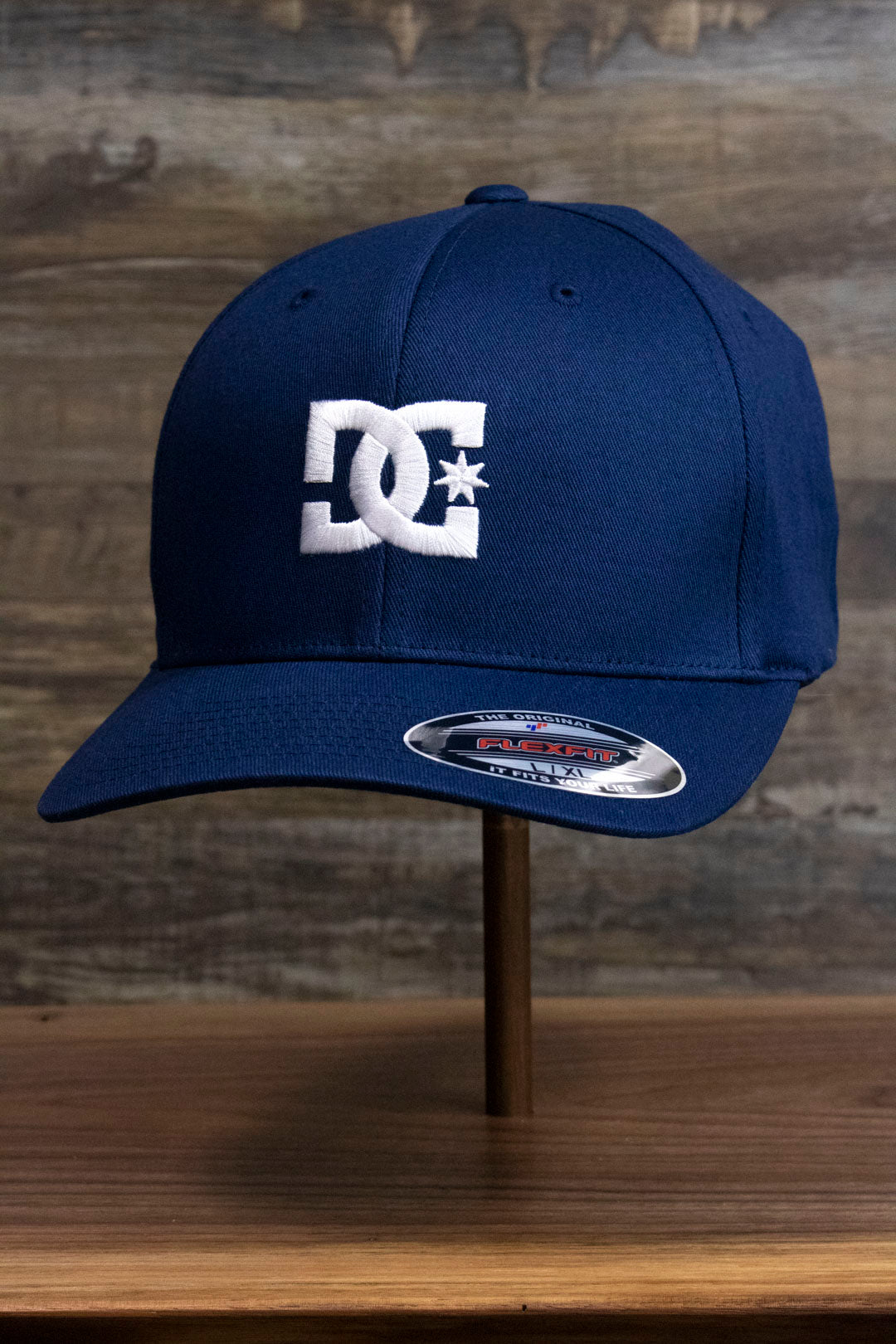 the Navy Blue Skater Hat | DC Shoes Blue Bottom Navy Flexfit Cap has a slightly bent brim and a flex fit.