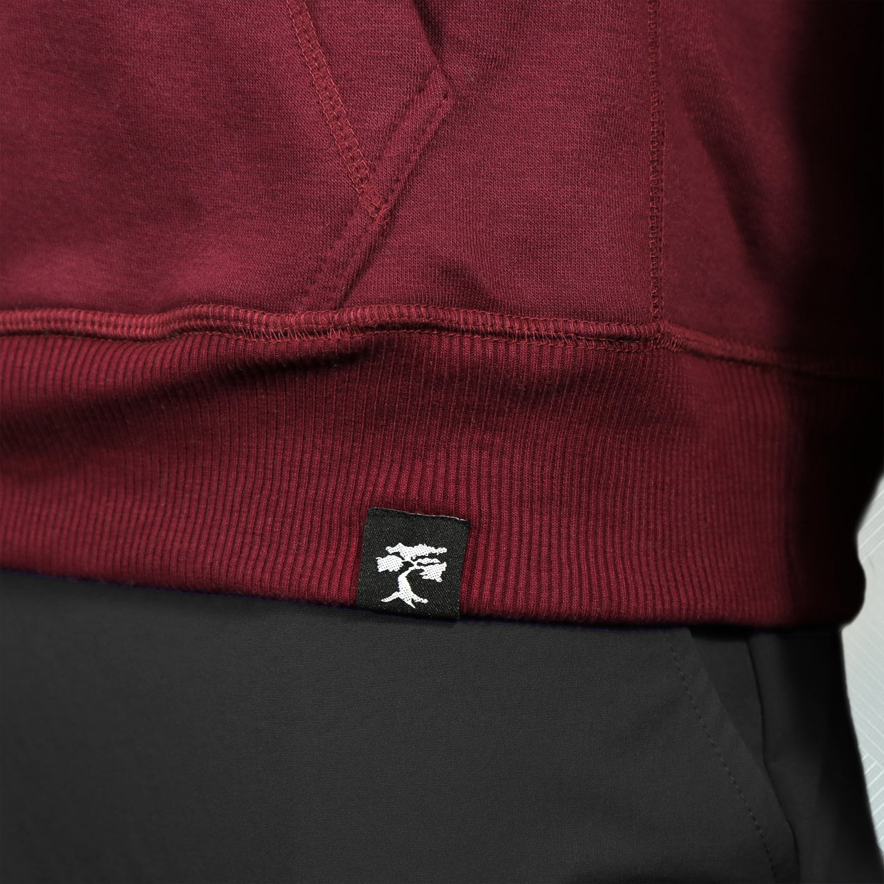 bonsai tree logo on the Maroon Unbasic Fleece Stash Pocket Sunset Park Tapered Pullover Hoodie | Fleece Dark Red Hoodie