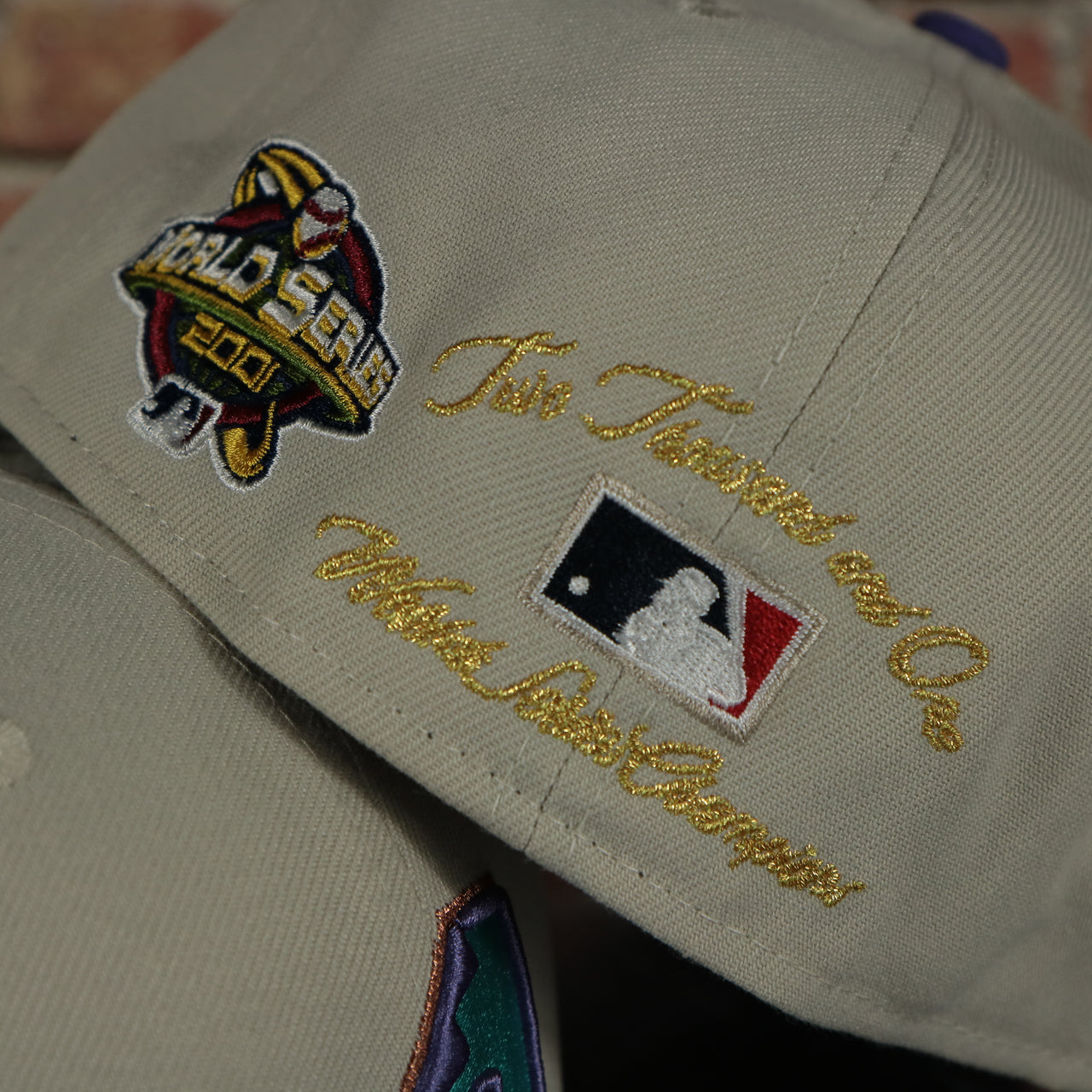 2001 world series champion script on the Arizona Diamondbacks Cooperstown World Class 2001 World Champions Two Tone Grey Bottom | Sand/Purple 59Fifty Fitted Cap