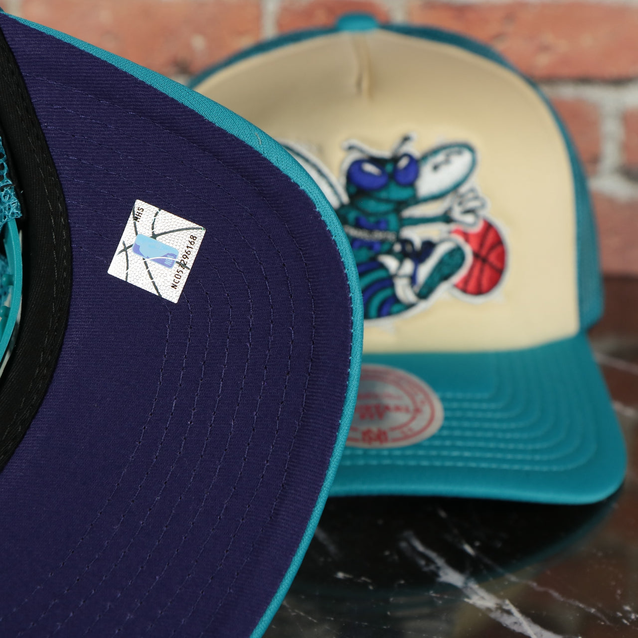 Charlotte Hornets Vintage "Charlotte" wordmark blue Bottom 2-Tone Foam Trucker Hat | Teal/Off-White Mitchell and Ness Hat