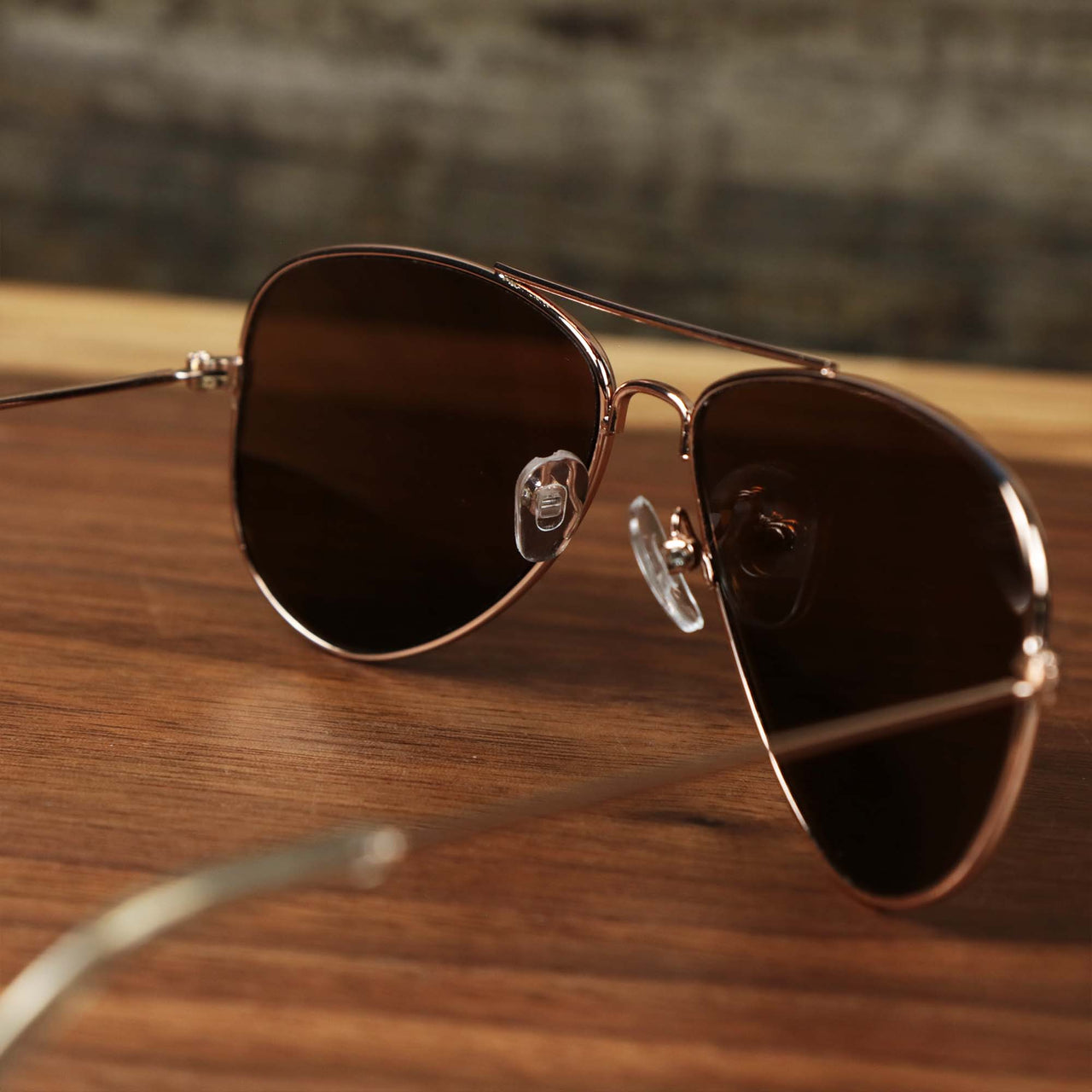 The inside of the Kid’s Aviator Frame Orange Lens Sunglasses with Rose Gold Frame