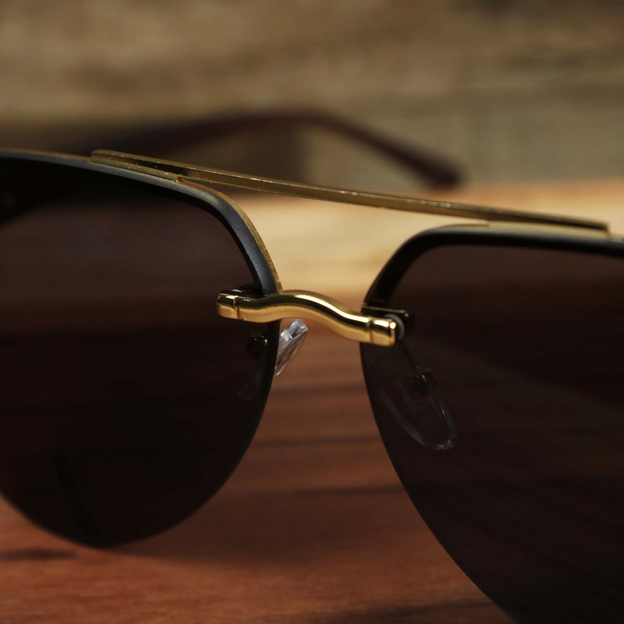 The bridge on the Round Aviator Frames Black Lens Sunglasses with Gold Frame