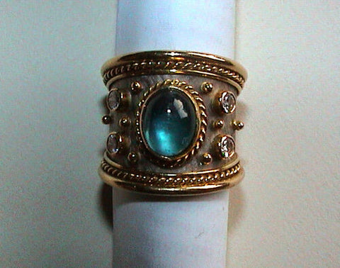 Gage-style ring with decorations surrounding a coloured gemstone