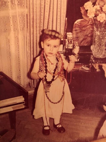 Katerina when she was 2 years old, covering herself with her grandmother's jewelries.