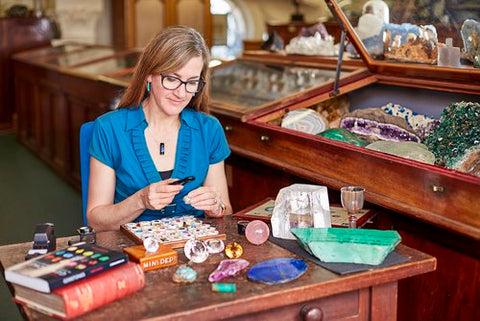 Photo of Robin Hansen examining gemstones