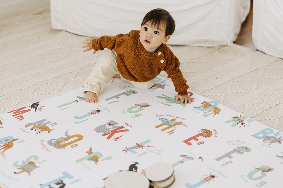 baby crawling on play mat