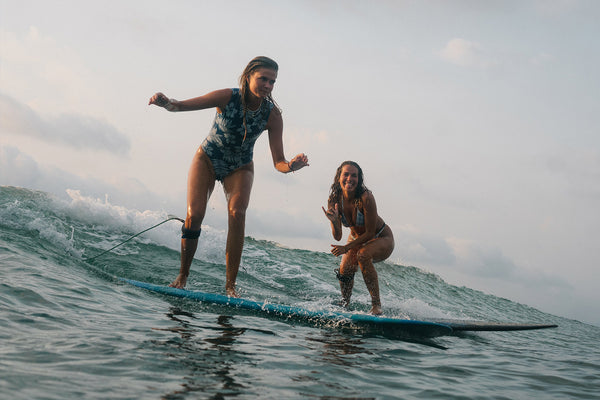 Two girls sharing a party wave in Lombok