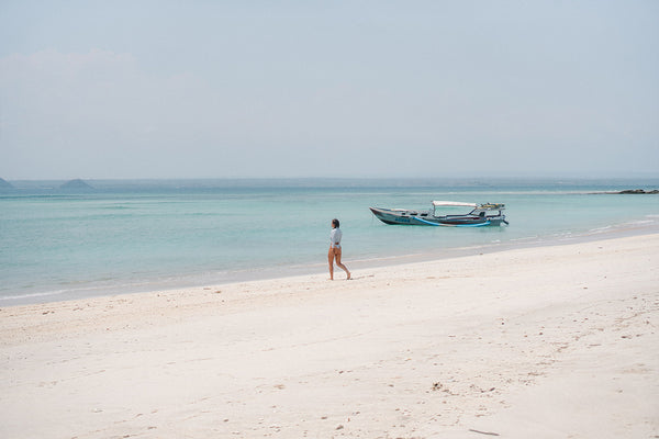 view of woman walking at the beach in lombok Indonesia
