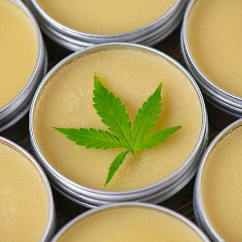 infused lotions with cbd - yellow cream with a thc leaf on top 