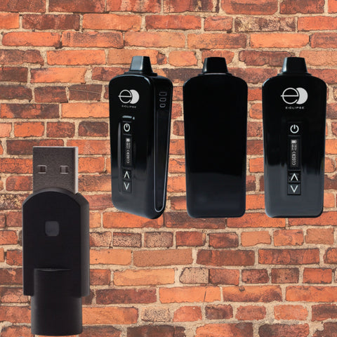eclipse black vaporizer with black usb charger. Brick wall