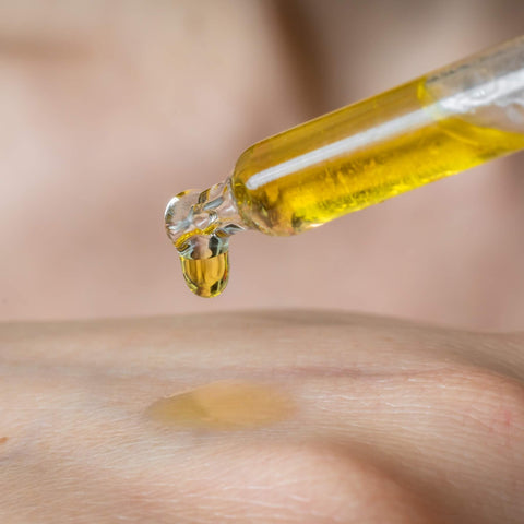 dropping cbd oil into your hands 