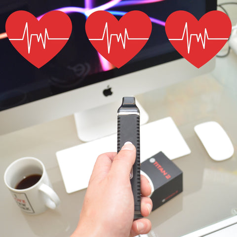 three red heart beating with a dry herb vaporizer being held in front of a computer 