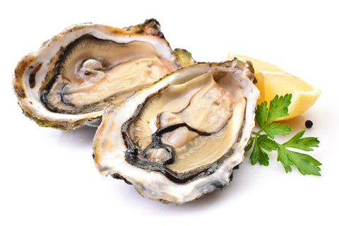 A plate of fresh oysters with lemon juice