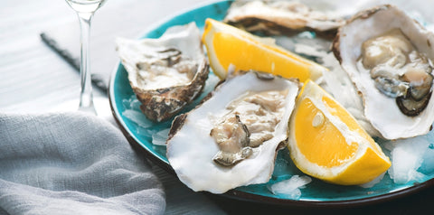 A plate of fresh oysters with lemon