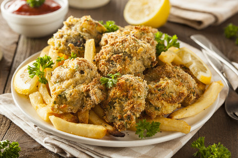 A plate of fried oysters with fries