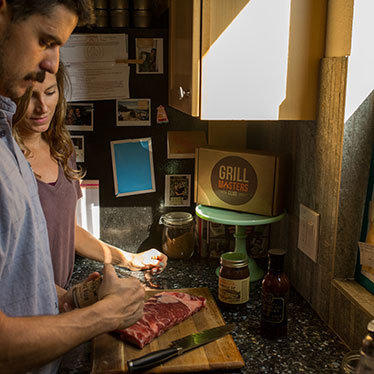 Man and Woman Preparing Meat