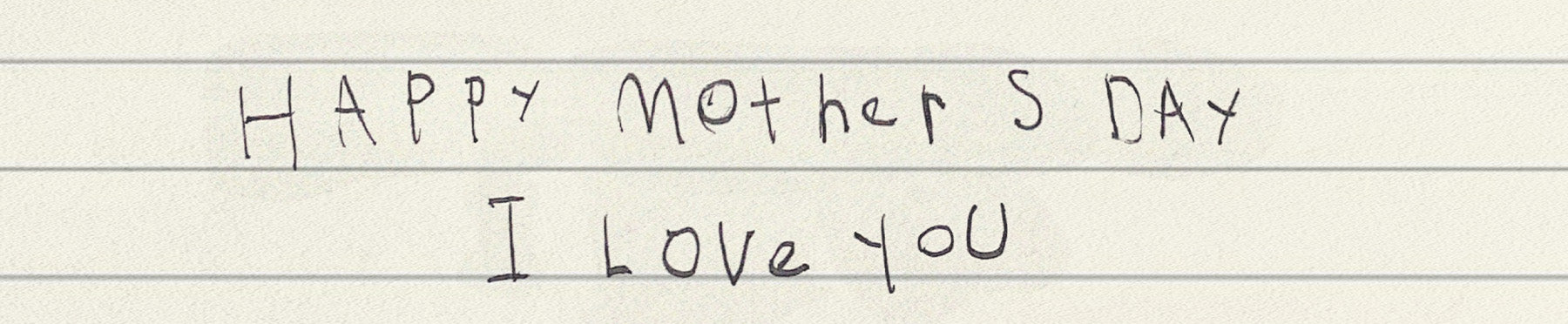 Child writing "Happy Mother's Day, I love you"