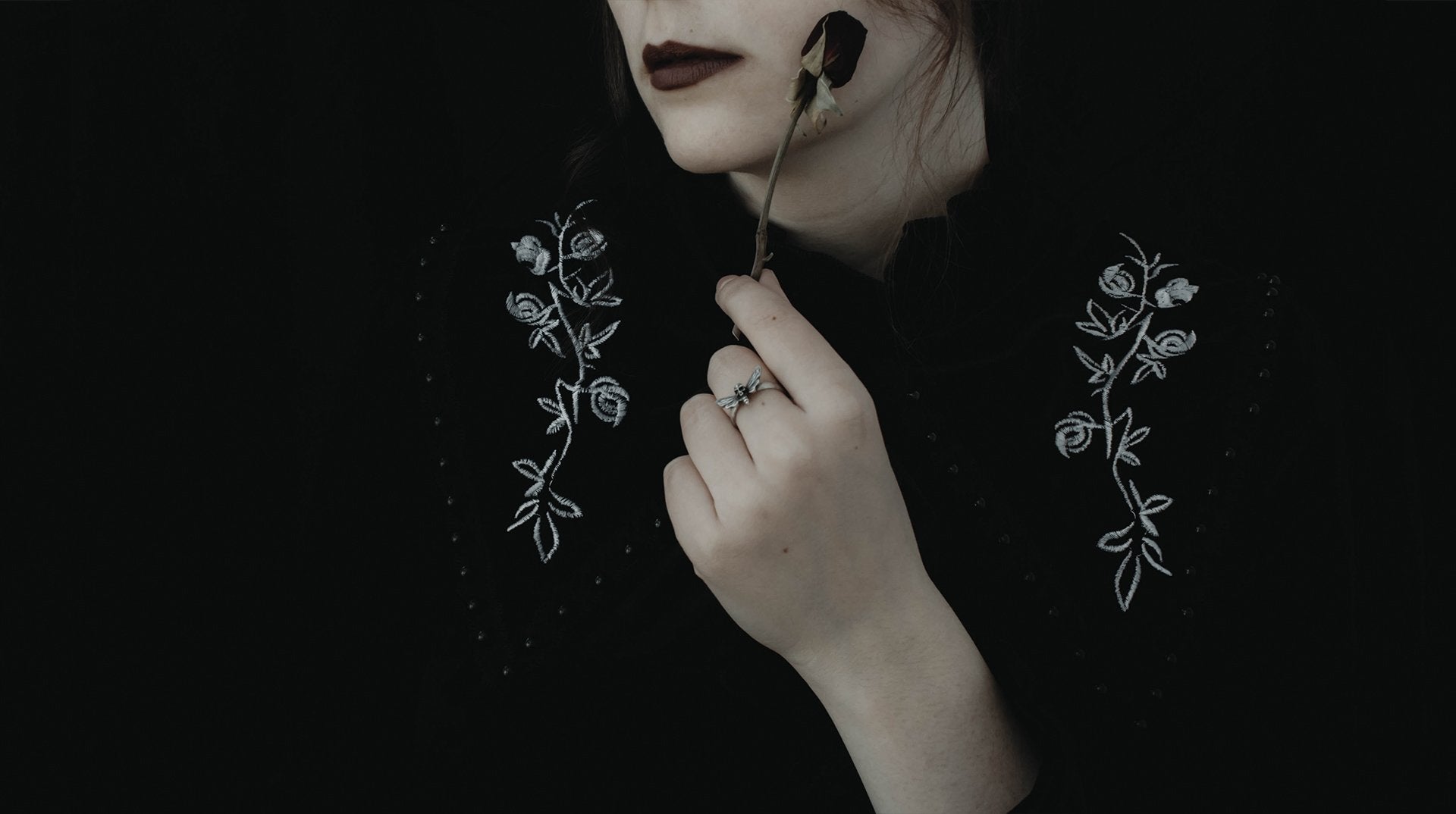 dark_aesthetic_woman_in_black_holding_flower_-Faq
