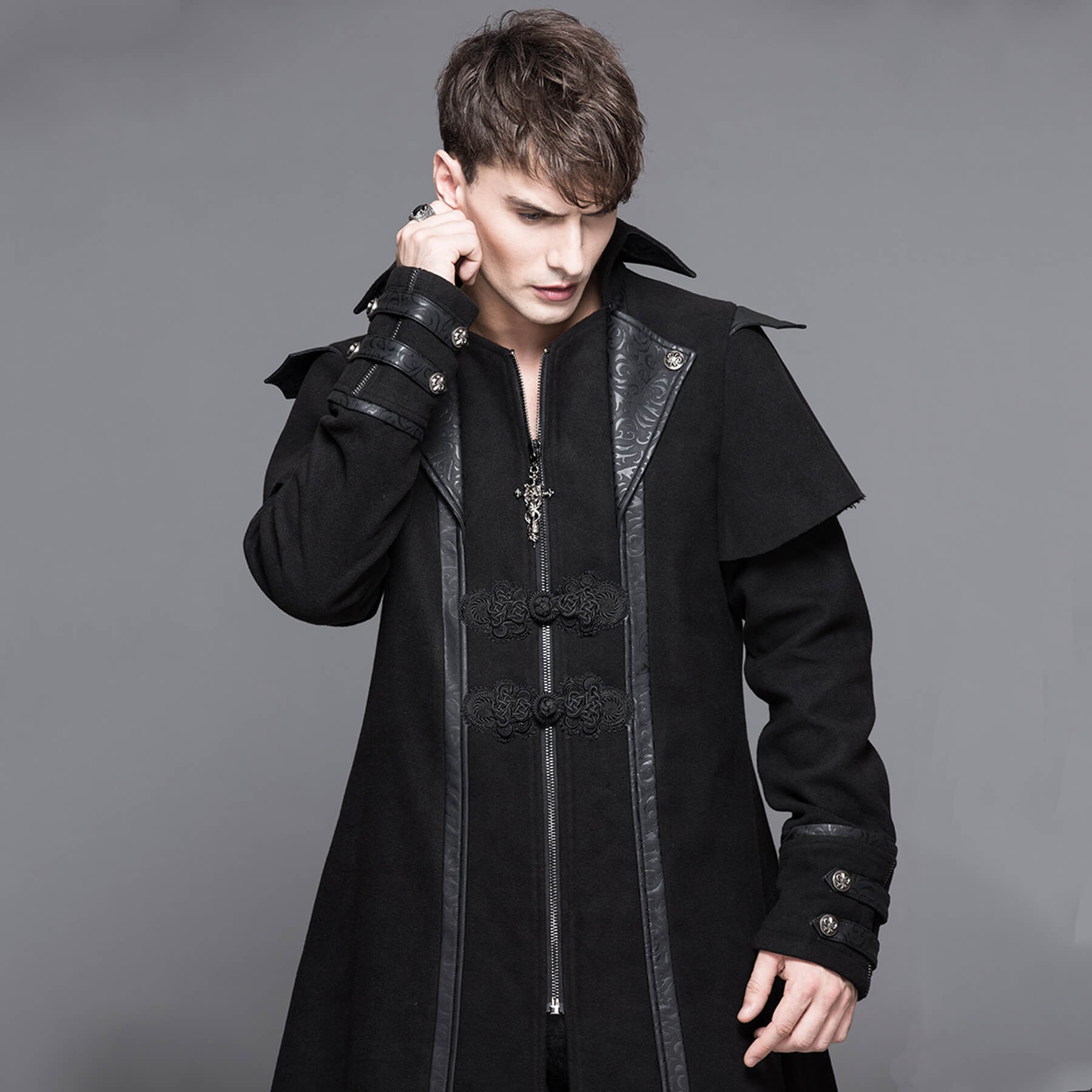 man-waist-up-posing-wearing-a-black-gothic-long-coat-in-grey-background_DDCJCT