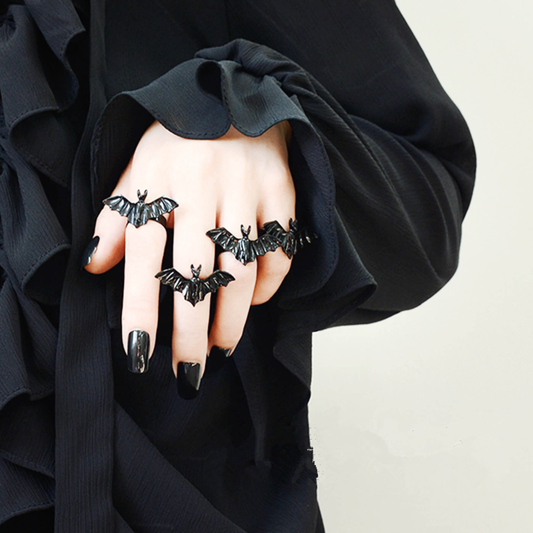 woman-in-black-blouse-wearing-two-black-bat-rings-JRCJ001