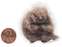 a Bower Studio sticker with an illustration of a porcupine, shown next to a penny for scale