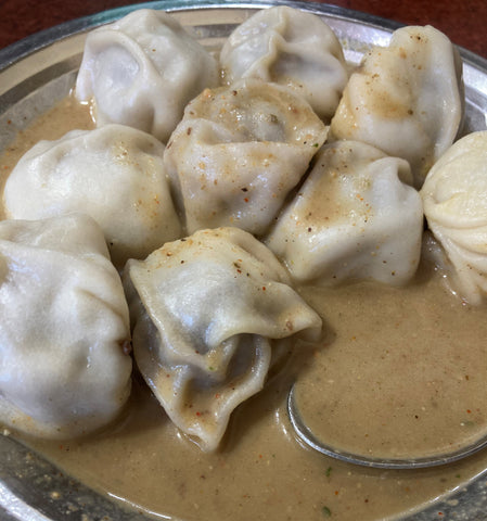 steaming plate of hot jhol momo 