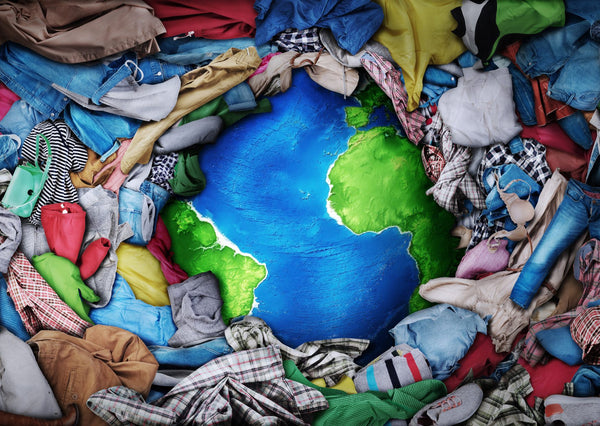 Picture of the earth being consumed by a pile of clothes