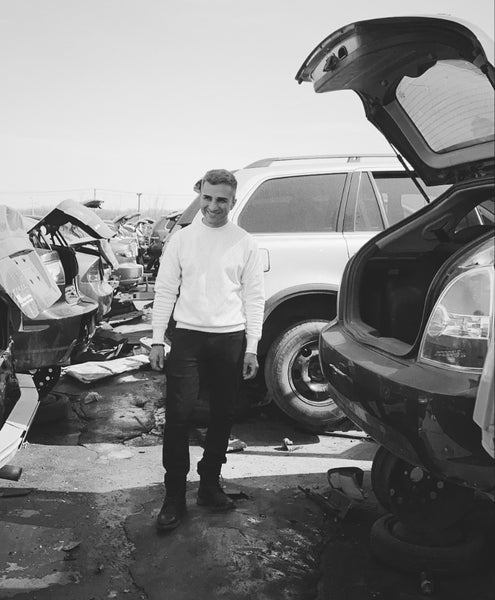 Bedi brand founder Inder Bedi stands next to an old car in a scrapyard