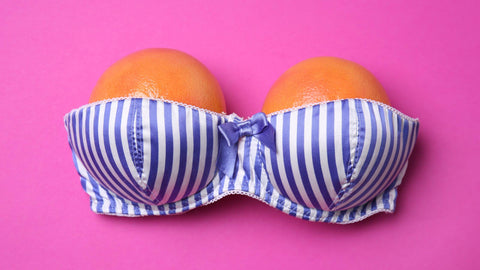 oranges in a striped satin strapless bra