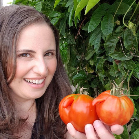 Daniela in the garden with her home grown tomatoes