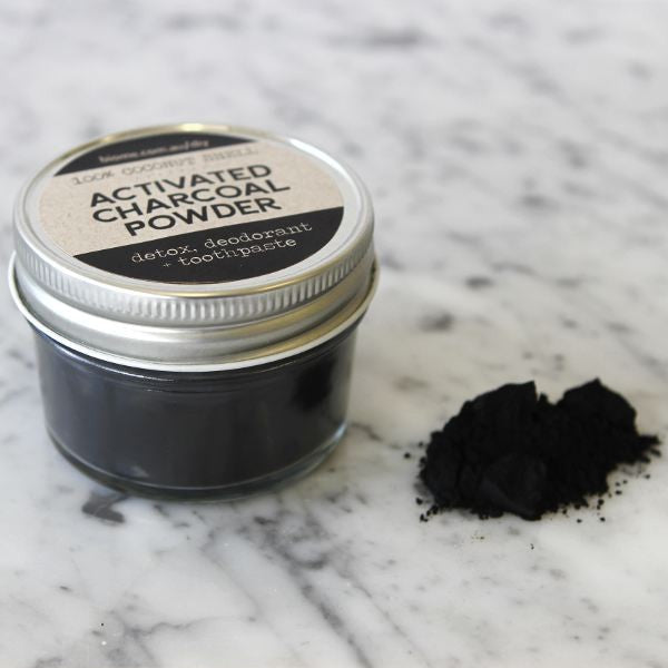 Activated charcoal powder in jar