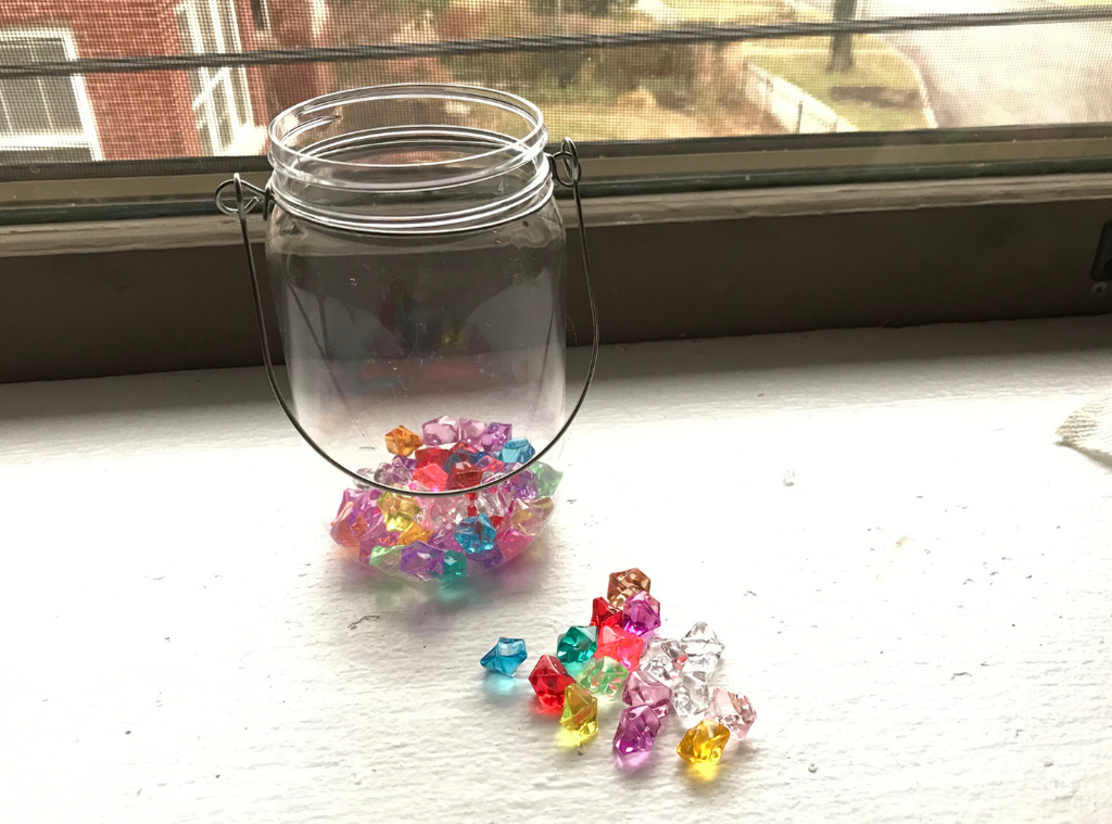 Pour package of colorful stones into the jar