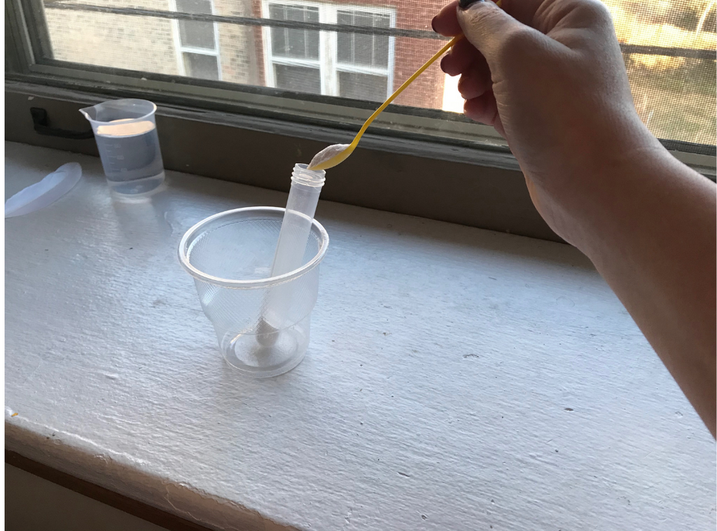 Scoop three spoonfuls of baking soda into test tube