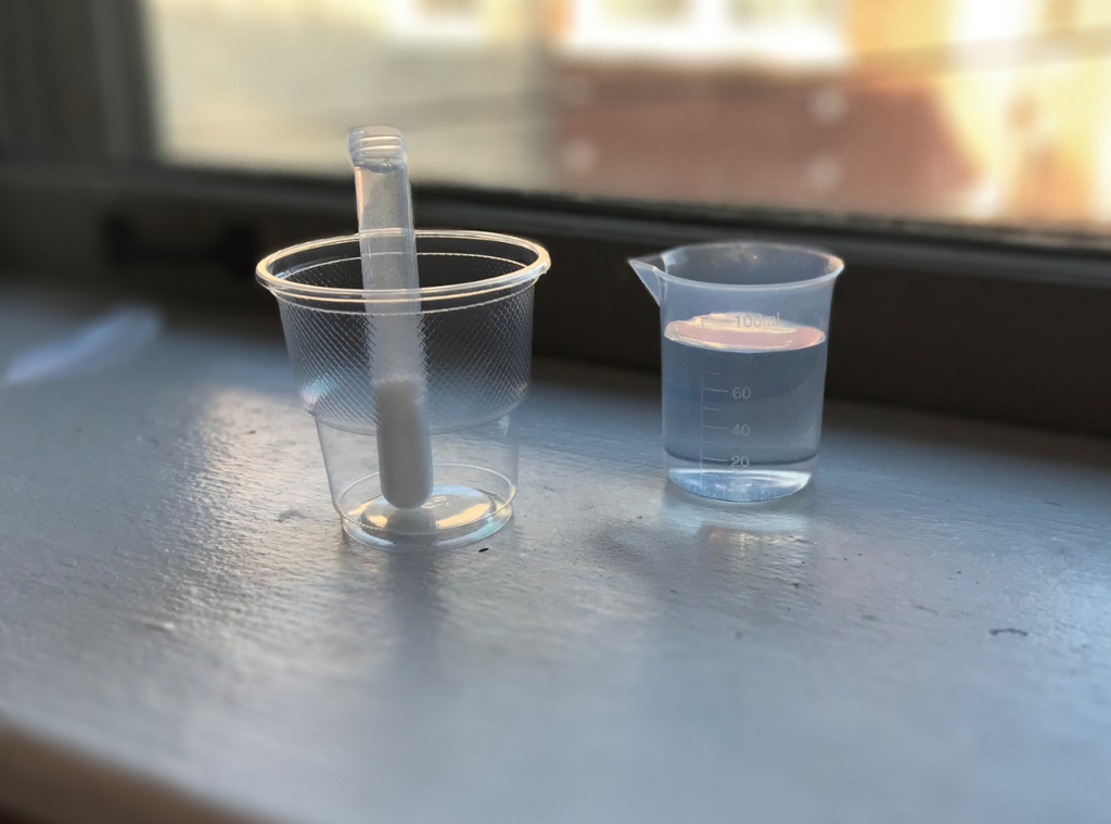 Pour water into test tube with 1/2 inch space at top