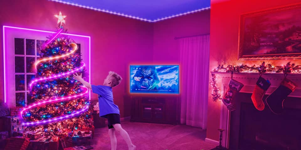The Christmas tree decorated with color-changing light strip attracts a child.