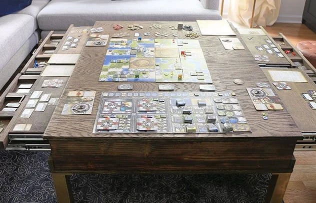 A DIY game table with drawers holds game props on the table.