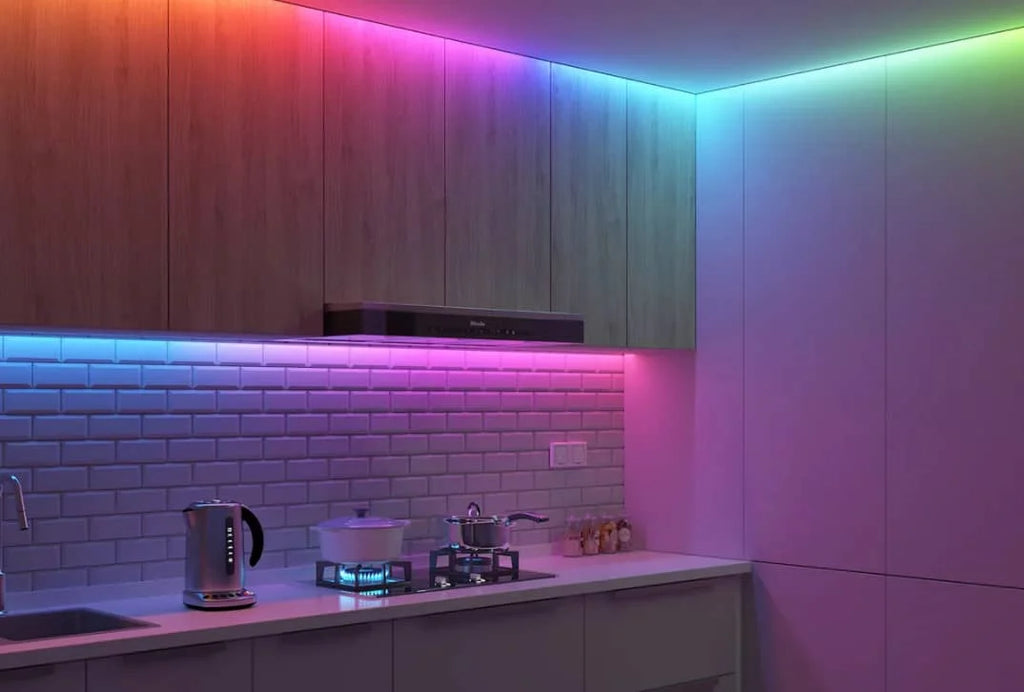 Kitchen with multi-color LED strip lighting under the cabinets and at the edge of the ceiling.