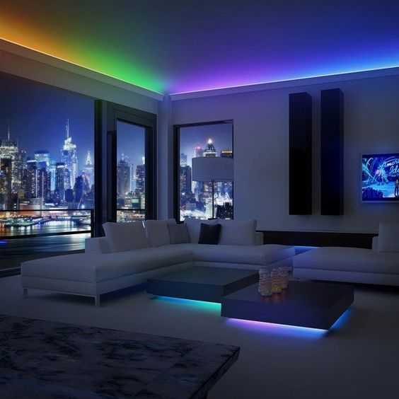 Multi-color LED strips are installed under the ceiling and table in the living room and turned on at night for rainbow lighting.