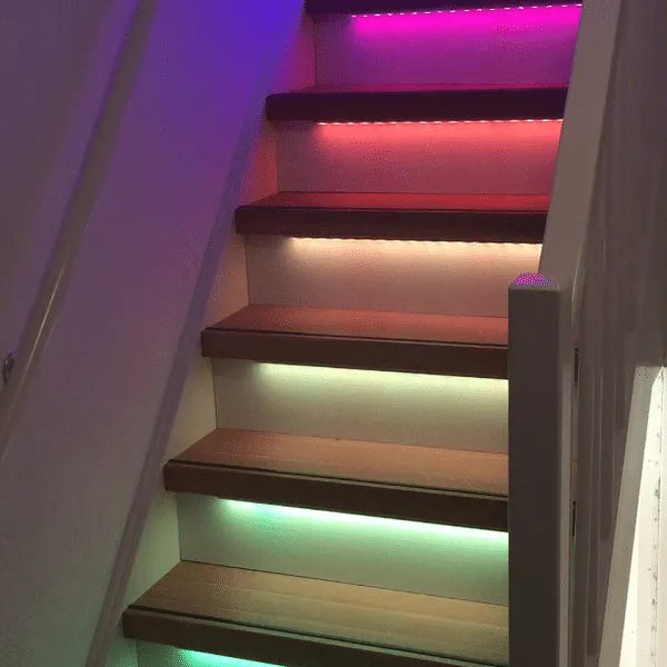 Multi-color LED strip lights are installed under each step of the interior staircase.