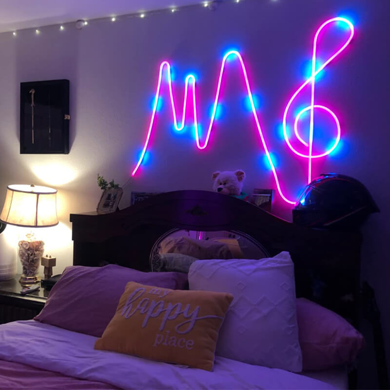 The bedside wall is adorned with neon strip lights custom-made into a treble clef.